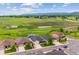 Aerial view of homes surrounded by green fields with scenic views of rolling hills at 9744 W Ontario Pl, Littleton, CO 80128