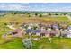 Aerial view of homes in a neighborhood in a pastoral setting with churches on distant hills at 9744 W Ontario Pl, Littleton, CO 80128