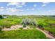 Spacious backyard with lush lawn, garden beds, and a wooden fence against a scenic backdrop at 9744 W Ontario Pl, Littleton, CO 80128