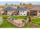 A well-maintained backyard features a patio with outdoor seating, green lawn, and meticulous landscaping at 9744 W Ontario Pl, Littleton, CO 80128