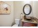 Stylish half bathroom featuring a vessel sink, granite countertop, and decorative mirror for added charm at 9744 W Ontario Pl, Littleton, CO 80128