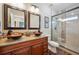 Tastefully designed bathroom featuring a double sink vanity, a glass shower, and stylish fixtures and accents at 9744 W Ontario Pl, Littleton, CO 80128