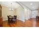 Elegant dining room featuring gleaming wood floors, a coffered ceiling, and stylish chandelier lighting at 9744 W Ontario Pl, Littleton, CO 80128