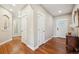 Inviting entryway featuring gleaming wood floors, white doors, and decorative mirrors for added elegance at 9744 W Ontario Pl, Littleton, CO 80128