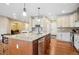 Gourmet kitchen with a large island, wine rack, and stainless steel appliances for modern convenience at 9744 W Ontario Pl, Littleton, CO 80128