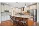 Gourmet kitchen featuring a large center island, granite countertops, and stainless steel appliances at 9744 W Ontario Pl, Littleton, CO 80128