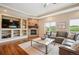 Cozy living room with a stone fireplace, built-in shelves, and ample natural light for relaxation at 9744 W Ontario Pl, Littleton, CO 80128