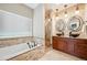 Luxurious main bathroom with soaking tub, walk-in shower, and a double sink vanity with decorative vessel sinks at 9744 W Ontario Pl, Littleton, CO 80128