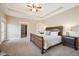Spacious main bedroom with tray ceiling, and a doorway leading to the ensuite bathroom and walk-in closet at 9744 W Ontario Pl, Littleton, CO 80128
