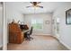 Bright office space featuring a classic wooden desk, neutral walls, and a view of the outdoors at 9744 W Ontario Pl, Littleton, CO 80128