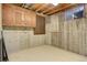 Unfinished basement area with exposed ceiling, concrete walls, and a small window, providing a utility space at 633 S Galena St, Denver, CO 80247