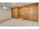 Finished basement room featuring carpet and wood paneling, with ample storage space at 633 S Galena St, Denver, CO 80247