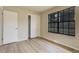 Neutral bedroom showcasing a large window, ample closet space, and light wood-look floors at 633 S Galena St, Denver, CO 80247