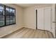 Bright bedroom with a view, featuring a large window, closet space, and neutral finishes at 633 S Galena St, Denver, CO 80247