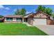 Charming single Gathering home features stone accents and a well-maintained lawn at 633 S Galena St, Denver, CO 80247