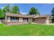 Single Gathering home with brick and stone accents and a freshly mowed front lawn at 633 S Galena St, Denver, CO 80247