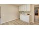 Bright eat-in kitchen features white cabinets, a breakfast bar, and modern flooring at 633 S Galena St, Denver, CO 80247