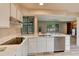 Gourmet kitchen features white countertops, stainless steel appliances, and laminate floors at 633 S Galena St, Denver, CO 80247