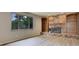 Bright living room with brick fireplace, bookcases, and a large window at 633 S Galena St, Denver, CO 80247