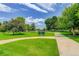 Scenic view of Ben Bezoff Park, with lush greenery, walking paths, and mature trees under a blue sky at 633 S Galena St, Denver, CO 80247