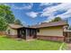 Cozy home featuring a screened in porch and brick accents, set against a lush green lawn at 633 S Galena St, Denver, CO 80247