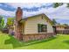 Charming home exterior featuring a brick chimney and foundation, complemented by a well-maintained lawn at 633 S Galena St, Denver, CO 80247