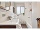 Well-lit bathroom with a modern sink, white tiled walls, and decorative accents at 2459 S Corona St, Denver, CO 80210