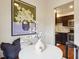 Dining area with an artistic flair, featuring hardwood floors, unique artwork, and a glimpse into the kitchen at 2459 S Corona St, Denver, CO 80210
