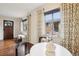Bright dining space with hardwood floors, large windows, and a stylish table setting near the front door at 2459 S Corona St, Denver, CO 80210