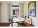 Cozy dining nook with built-in seating, hardwood floors, and a view of the outdoors through patterned curtains at 2459 S Corona St, Denver, CO 80210