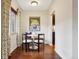 Inviting dining area featuring a charming table set, hardwood floors, and natural light from the window at 2459 S Corona St, Denver, CO 80210