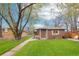Charming brick home with a well-manicured lawn, mature trees, and a cozy front porch area at 2459 S Corona St, Denver, CO 80210
