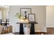 Chic hallway console table adorned with a butterfly portrait, adding an artistic touch to the living space at 2459 S Corona St, Denver, CO 80210
