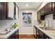Functional kitchen featuring sleek countertops, stainless steel sink, and a window overlooking the outdoor landscape at 2459 S Corona St, Denver, CO 80210