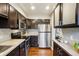 Updated kitchen with stainless steel appliances, subway tile backsplash, and dark wood cabinets for a modern touch at 2459 S Corona St, Denver, CO 80210