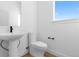 Bright half bath with modern fixtures, pedestal sink, and neutral color palette at 14241 Currant St, Broomfield, CO 80020