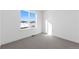 Bright bedroom featuring a large window with scenic views and neutral carpeting at 14241 Currant St, Broomfield, CO 80020