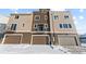 Stylish townhome with balcony above garage, featuring a modern design and snow-covered landscape at 14241 Currant St, Broomfield, CO 80020