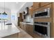 Modern kitchen with stainless steel appliances, range hood, tile backsplash and large island at 14241 Currant St, Broomfield, CO 80020