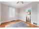 Bright bedroom with hardwood floors and a view into the bathroom at 2617 Albion St, Denver, CO 80207