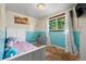 Bright bedroom with blue accent wall and plush toys at 8960 Judson St, Westminster, CO 80031
