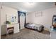 Carpeted bedroom with a makeup vanity and natural light at 8960 Judson St, Westminster, CO 80031