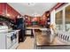 Eat in kitchen with dark cabinetry, white appliances, and tile flooring at 8960 Judson St, Westminster, CO 80031