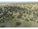 Aerial view of a community surrounded by beautiful landscape with mature trees and homes at 7390 Rafter Rd, Franktown, CO 80116