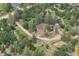 Idyllic aerial view of a home nestled amongst a lush green forest on a sunny day at 7390 Rafter Rd, Franktown, CO 80116