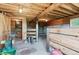 Rustic barn interior featuring a wooden frame, concrete foundation, and exposed lighting at 7390 Rafter Rd, Franktown, CO 80116