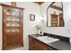 Bathroom featuring a vintage cabinet, antique mirror, and historic design elements at 7390 Rafter Rd, Franktown, CO 80116
