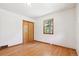 Neutral bedroom with hardwood floors and a window providing ample natural light at 7390 Rafter Rd, Franktown, CO 80116