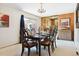 Dining room with wood floors, sliding glass door, chandelier, and a view to other rooms at 7390 Rafter Rd, Franktown, CO 80116