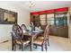 Formal dining room with chandelier, dark wood table, and built-in display cabinet at 7390 Rafter Rd, Franktown, CO 80116